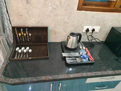 a kitchen counter with a tea kettle and utensils at Vani Vilas Luxury Villa in Mysore