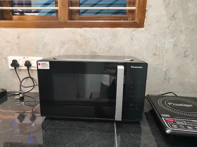 a microwave sitting on top of a counter at Vani Vilas Luxury Villa in Mysore