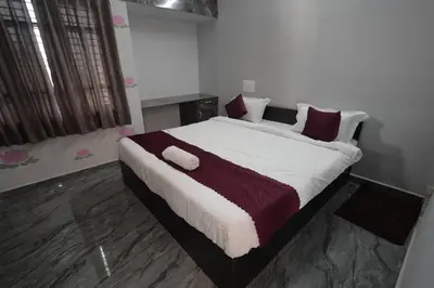 a bedroom with a large bed with red and white pillows at Vani Vilas Luxury Villa in Mysore