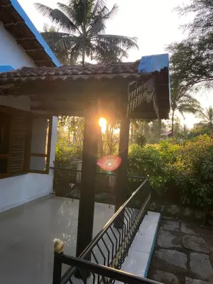 a porch with a bench and a pergola at Nirvana Private Villa in Kushālnagar