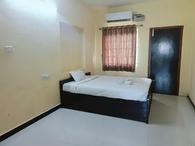 a small bedroom with a bed and a window at GM nest in Coimbatore