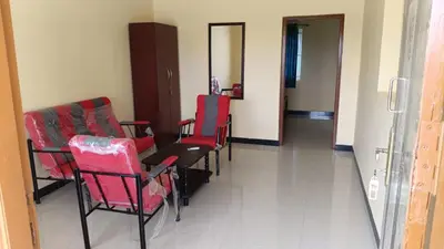 a dining room with red chairs and a table at GM nest in Coimbatore