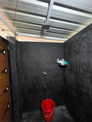 a bathroom with a red bucket in a room at The Kadu in Tāzhekkod