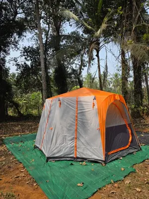 an orange and gray tent on a green sheet at The Kadu in Tāzhekkod