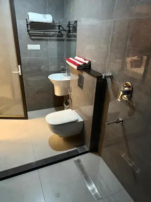 a bathroom with a toilet and a sink at Idam home stay in Wayanad