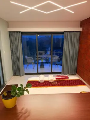 a bedroom with a large bed with a view of a patio at Idam home stay in Wayanad