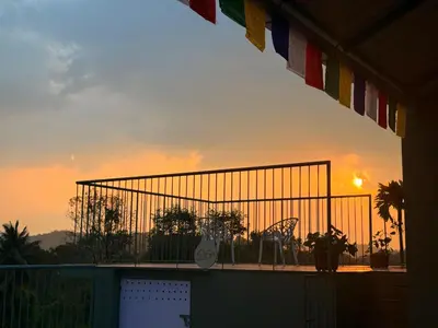 a view of the sunset from the balcony of a building at Idam home stay in Wayanad