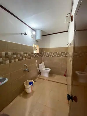 a bathroom with a toilet and a sink at Coorg jungle Cottage in Kushālnagar