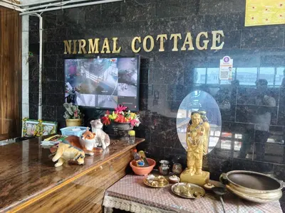 a shop window with a sign that reads internal coffee at Hotel Nirmal Cottage Gobichettipalayam in Siruvalūr