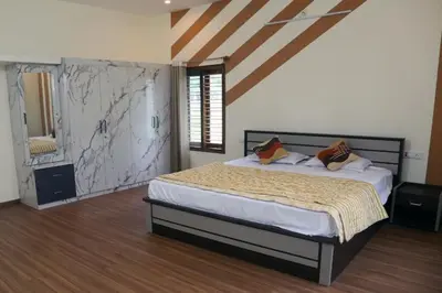 a bedroom with a large bed in a room at Nirmala Dhama Farmstay - Serene Family Retreat