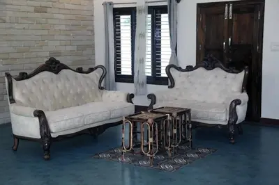 two white couches and a table in a room at Nirmala Dhama Farmstay - Serene Family Retreat