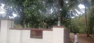 a man walking through a gate at a zoo at Nihave in Attappādi