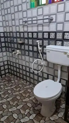 a bathroom with a toilet and a sink at Aura Eco Friendly Resort in Sultan Bathery
