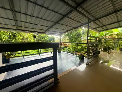a view from the balcony of a house with plants at Wayanad Shas Villa in Padinjarathara