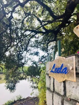 a sign that says leela on a stone wall at Leela in Green Island