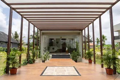 an open deck with potted plants in a house at The fox resort in Bandipūr