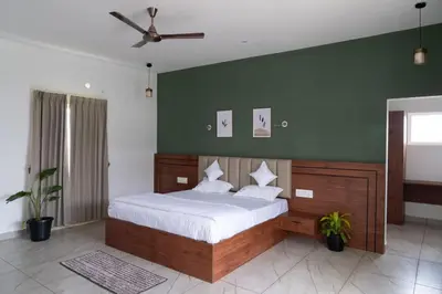 a bedroom with a bed and a green wall at The fox resort in Bandipūr