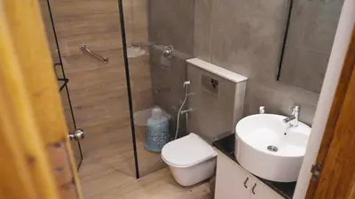a bathroom with a shower and a toilet and a sink at 3 Bhk Villa Ooty - Casa de Amor by EBR in Ooty