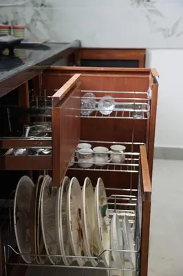 a cabinet with plates and bowls in it at KK Service Suites in Coimbatore