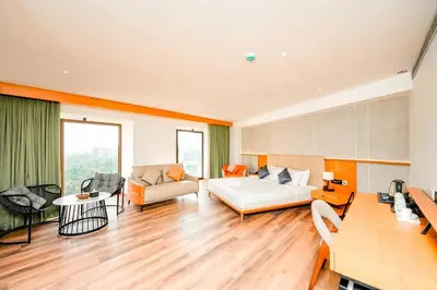 a living room with a couch and a table at Nestlay Suites by TC One in Kozhikode
