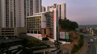 a view of a city with tall buildings and a highway at Nestlay Suites by TC One in Kozhikode