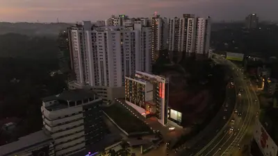 an overhead view of a city with tall buildings at Nestlay Suites by TC One in Kozhikode