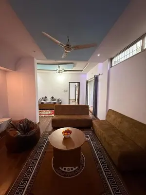 a living room with a couch and a table at Siddhartha Residency in Mysore