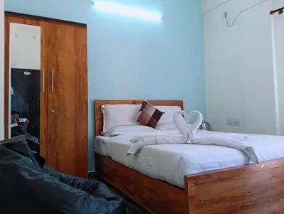 a bed with a wooden frame with a stuffed animal on it at Siddhartha Residency in Mysore