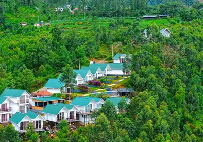 an aerial view of a village with houses at Gardenia Pool Resort Kanthalloor by VOYE HOMES Mountain View Stay Near Bhramaram view Point in Kanthalloor