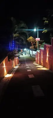 an empty street at night with a cross in the background at South point in Ammatti