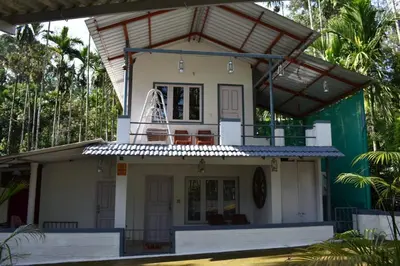 a house with a balcony on top of it at South point in Ammatti