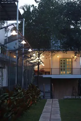 a house with lights on the side of it at Castle DAK in Trichūr