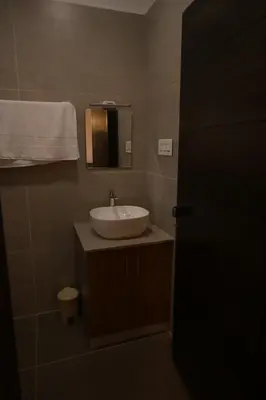 a bathroom with a sink and a mirror at Castle DAK in Trichūr