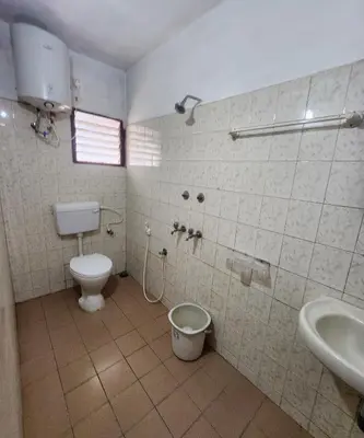 a bathroom with a toilet and a sink at DADIL HOME STAY ooty in Ooty