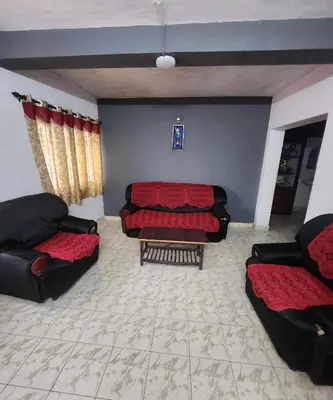 a living room with two couches and a couch at DADIL HOME STAY ooty in Ooty
