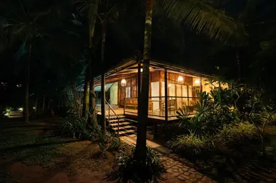 a small cabin in the woods at night at Discovery Village Kabini in Antarasante