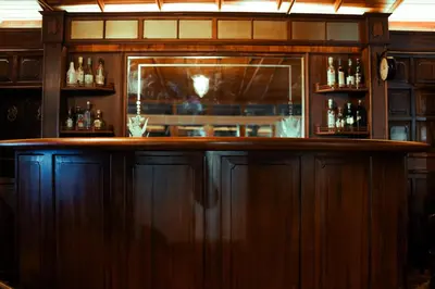 a bar with a wooden counter in a room at Milntown Bungalow 200 years old Colonial Stay in Coonoor in Coonoor