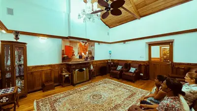 a group of people sitting in a living room at Milntown Bungalow 200 years old Colonial Stay in Coonoor in Coonoor