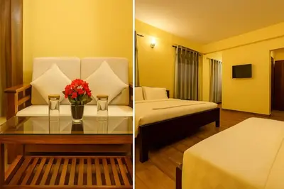 a hotel room with a bed and a table with flowers at Dreamview Cottage by BEN Groups in Ooty