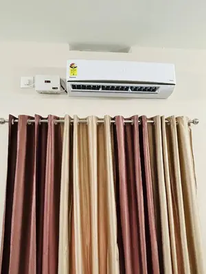a heater and curtains on a curtain rod at Cosy Stays, 2 Adjacent Apartments in Irinjalakuda in Irinjālakuda