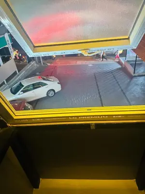 a picture of a white car in a parking lot at AZURE stay happy in Pudunagaram