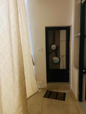 a room with a door with a curtain next to a room at AZURE stay happy in Pudunagaram