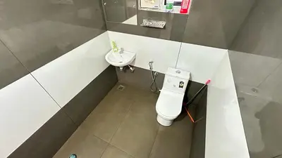 a small bathroom with a toilet and a sink at Hima Pool Villa in Padinjarathara