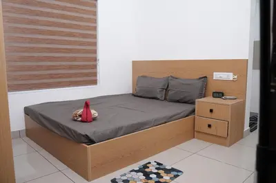 a bedroom with a bed with a red cape on it at Serene Cottage - Home away from Home in Vythiri