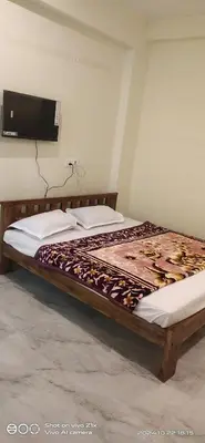 a bed sitting in a room with at SOWMYA RESIDENCy in Piriyāpatna