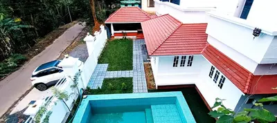 an aerial view of a house with a swimming pool at Heaven Cloud Stay Hub Attappadi in Attappādi