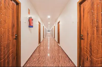 a hallway with wooden doors and a long aisle at Sakthi Grand in Erode