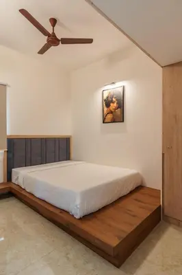 a bedroom with a bed and a ceiling fan at Everest Serenity Service Apartment in Pīlamedu
