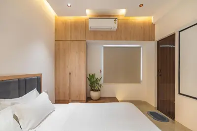a bedroom with a white bed and a window at Everest Serenity Service Apartment in Pīlamedu