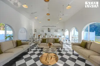a living room with couches and a table at StayVista at Mudra Tattva - Pvt Pool,Lawn,Jacuzzi 2BR Luxury Rooms in Suntikoppa